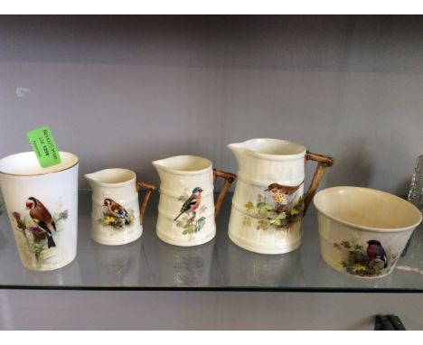 A five piece Royal Worcester set designed by William Powell including three jugs in graduated sizes, a bowl and a cup.