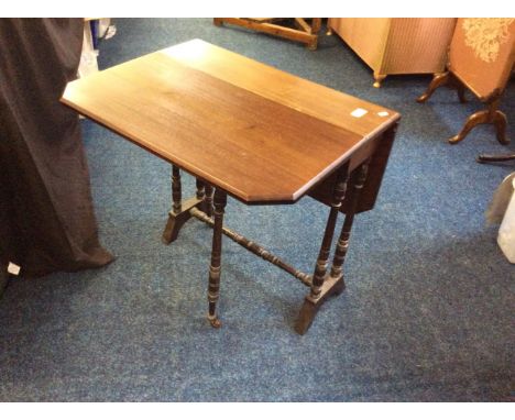 A mahogany drop leaf table with turned gate leg support