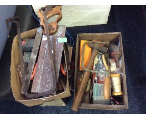 A collection of various old tools including saws, hammer etc.