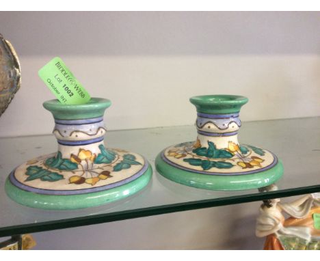 A pair of Burleigh ware Charlotte Rhead green candlestick holders.