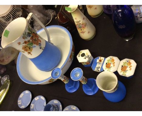 A set of Tams ware items including a pair of candlestick holders, a large jug and basin, a pair of lidded pots etc.