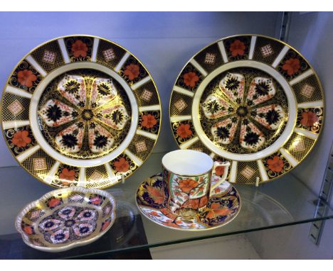 Two Imari pattern plates with a small dish and cup and saucer.