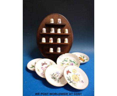 A collection of Royal Worcester thimbles and pin dishes 
