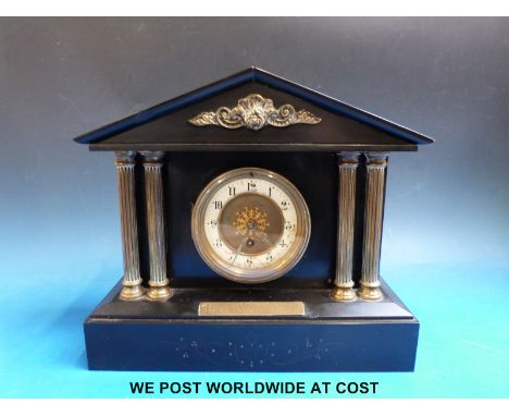 A slate mantel clock with plaque of presentation to 'The Rev T.R.F Jeffreys' with Roman pillars and brass and ivory face