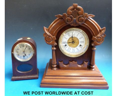 A British United Clock Co Birmingham mantel clock with a two train movement, cherub decoration to dial and pendulum and key, 
