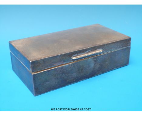 A hallmarked silver cigarette case with engine turned lid, width 16cm