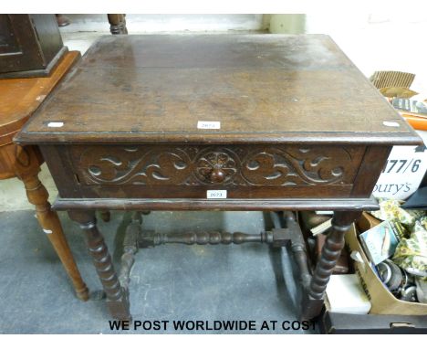 A small oak desk with simple carved drawer and bobbin turned legs and stretcher (h74cm x w70cm x 53cm)