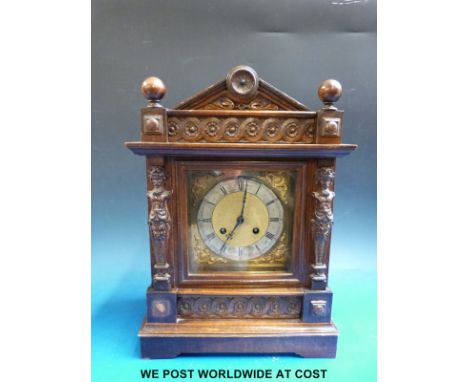 A late 19thC two train mantel clock with carved oak case 