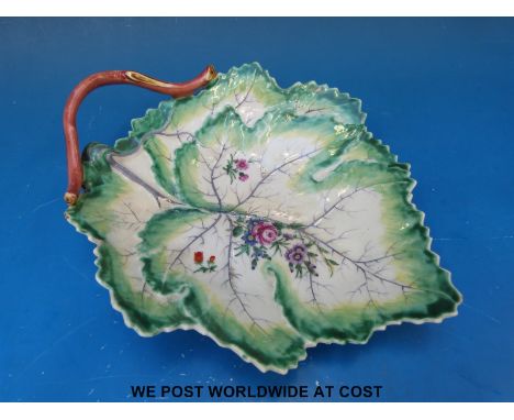 An early Worcester 'Dr Wall' leaf dish moulded with overlapping vine leaves edged in green, painted with colourful flowers, c