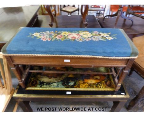 A oak duet piano stool with floral tapestry set and stretcher supports 