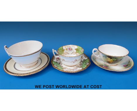 A Royal Worcester cup with hand painted roses, Coalport and Irish armorial cups and saucers