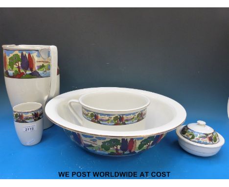 A five piece toilet set decorated with a landscape pattern possibly an early Clarice Cliff design by Newport Pottery 