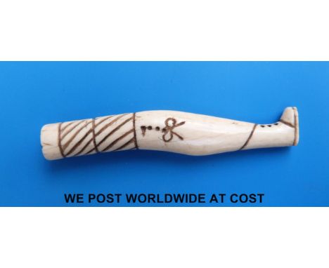 An 18thC sailor carved and decorated probably whale bone figural lady's leg pipe tamper/stopper, scrimshaw like engravings in