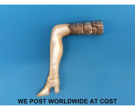 An 18th/19thC carved mother of pearl pipe tamper/stopper in the form of a lady's leg, engraved decoration to shoe, the top wi