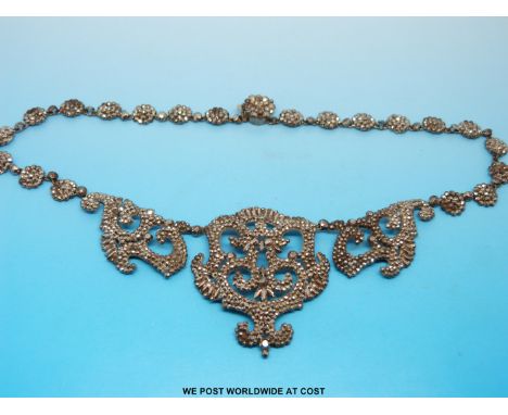 A Georgian/ early Victorian cut steel necklace formed of a central panel flanked by two smaller panels, the remainder made up