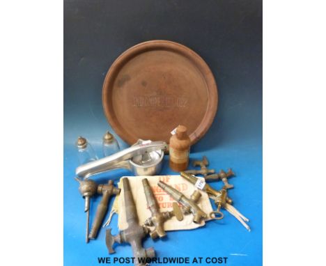 A collection of breweriana and kitchenalia including Ind Coope and Allsopp bakelite trays, vintage brass beer taps, squeezers