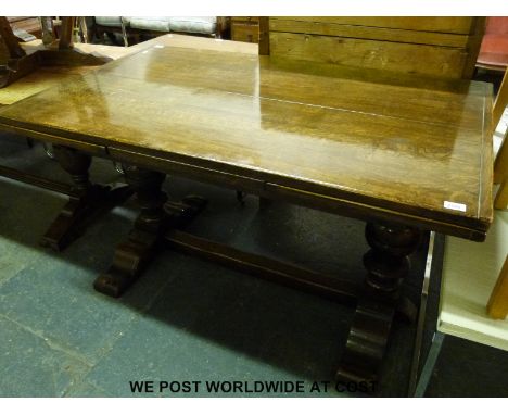 An oak draw leaf refectory table by G T Rackshaw of Worcester