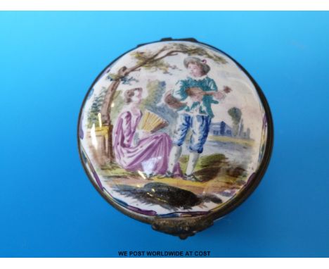 A George III period French enamel patch box, the lid with decoration of a young man serenading a girl seated beneath a tree. 