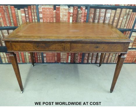 A 19thC walnut side table or desk with leatherette inset top and two drawers to front, brass plaque for T H Filmer & Sons Lon