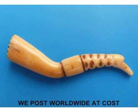 An 18thC carved bone figural lady's leg pipe tamper/stopper with boot detail and brass pins inset decoration (approx 2.25" le