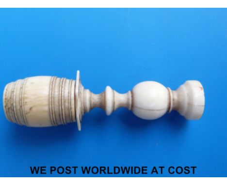 A carved ivory 18th/19thC pipe tamper/stopper in the form of a barrel on a column, which unscrews revealing three miniature d