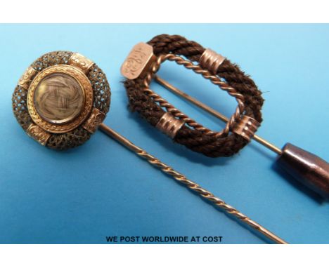 Two 19thC yellow metal stick pins, one inset with hair to the centre surrounded by plaited hair, the other yellow metal and p