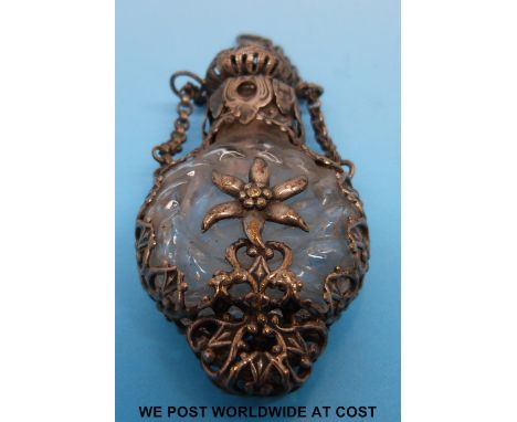 A 19thC glass scent bottle with moulded sunburst design to one side and white metal filigree surround, six petal flower, pier