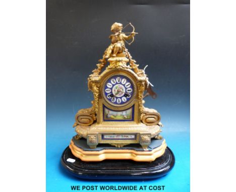 A 19thC French ormolu mantel clock with floral and landscape decoration to porcelain panels and dial, cupid featured as top f