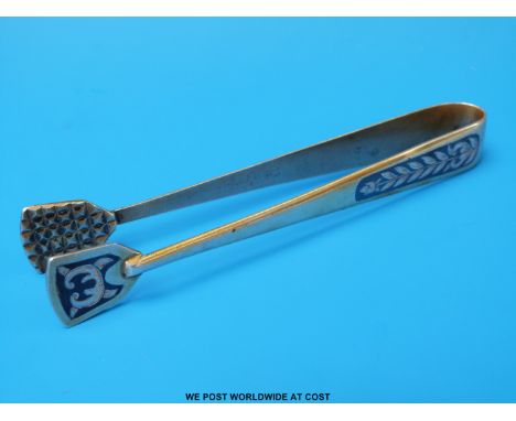 A pair of Russian Niello white metal sugar tongs marked 875 with letter M, hammer and sickle and C4-6