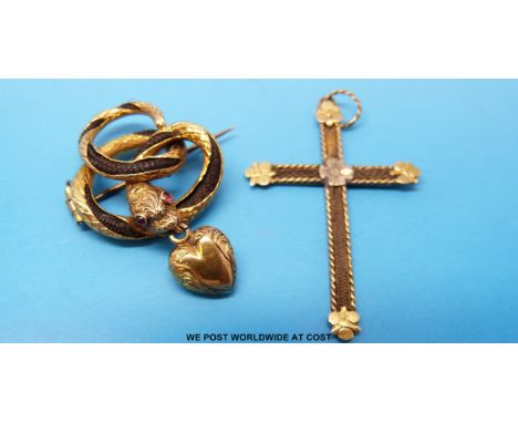 A 19thC yellow metal brooch in the form of a snake its body twisted around in a knot and with cut away areas revealing plaite