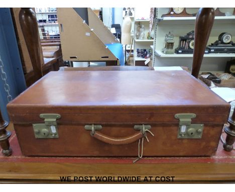 A vintage leather suitcase with nickel fittings (66cm wide)