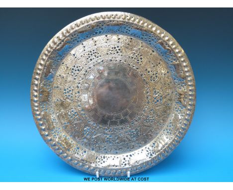 An Indian / Eastern pierced platter with repoussé decoration of elephants (diameter 30.5cm) and a jadeite pipe 
