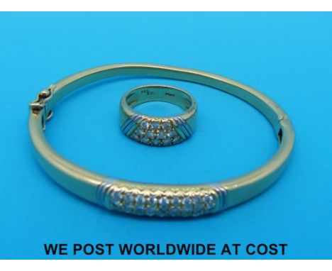 An 18ct gold bangle set with 30 round brilliant cut diamonds (total 0.8ct) and matching ring set with 12 round brilliant cut 