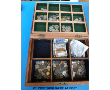 A large collection of overseas coinage and some bank notes in a vintage collector's box