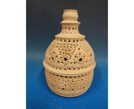 A pierced terracotta lamp in two parts to house candles