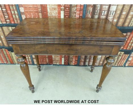 A 19th century fold over games table with felt playing surface, raised on four turned legs (W85.5cm x D42.5cm x H76cm