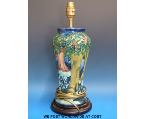 A Moorcroft table lamp decorated with trees (38cm tall)