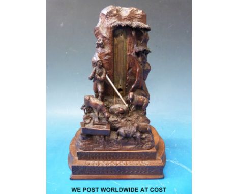 A black forest carved desk thermometer with figural and pastoral decoration, height 22cm