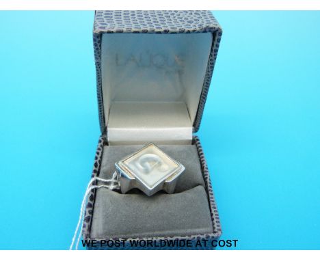 A ring set with a Lalique panel depicting a woman 