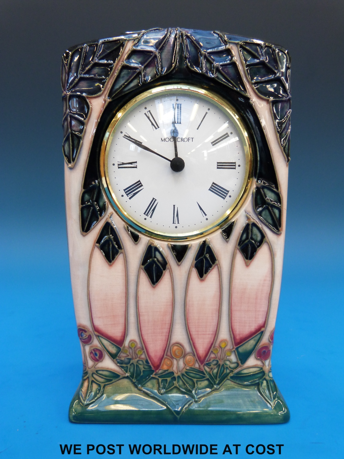 A Moorcroft mantel clock in the Cluny pattern (15cm tall)