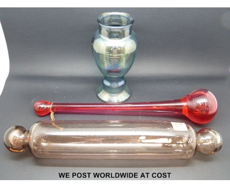 An early Victorian brown glass rolling pin with red glass novelty item and grey/green glass vase 