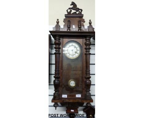A Vienna regulator style mahogany wall clock with carved horse finial 