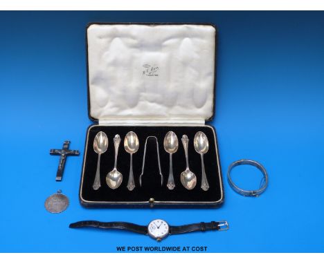 A silver-cased wristwatch, a silver bangle, a white metal pendant, a silver-mounted crucifix inscribed 1857 & 1858 and a case