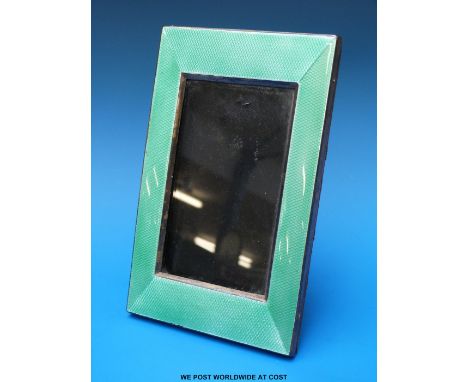 An Art Deco hallmarked silver guilloché enamel photograph frame to suit 5 x 3" photo, with stand to rear, Birmingham 1929, ma