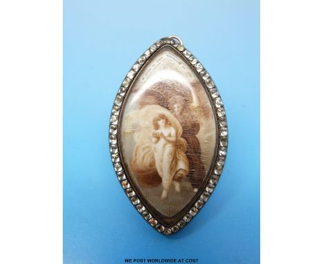 A Georgian/Victorian marquise shaped yellow metal pendant/ brooch set with a painted ivory plaque depicting a two women in he