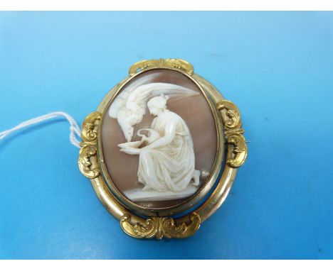 A swivel mourning brooch with a cameo depicting a woman feeding an eagle to one side and  a glass compartment to the other fo