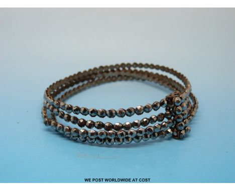 A Victorian cut steel bangle made up of four bangles joined together by a bar 