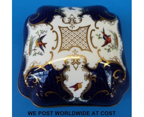 A Coalport covered dish with hand decorated exotic birds against a cobalt blue scale ground in a variation of the batwing pat