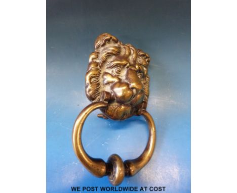 A vintage brass lion mask door knocker