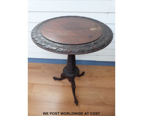 A carved oak tripod table (diameter 52cm, height 74cm)